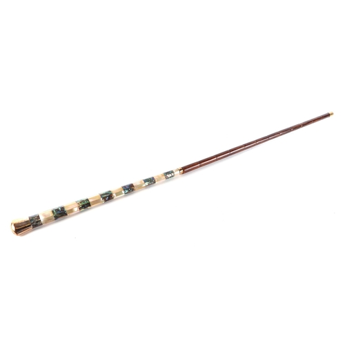 38 - A partridge wood swordstick with mother of pearl handle and gold plated terminal, having a blued tap... 