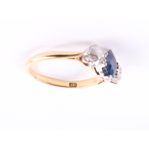 384 - An 18ct gold three-stone diamond and sapphire ring, the diamonds approx 4.8mm diameter, the sapphire... 