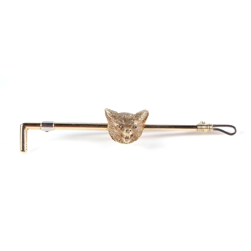 391 - A 14ct gold and platinum stock pin in the form of a fox mask and whip, 6.8g, cased.