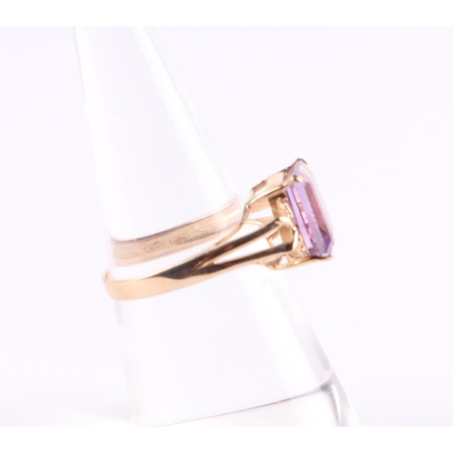 394 - A 10ct gold ring set with a large rectangular amethyst, approx UK size N, 2.6g.