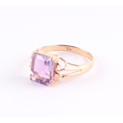 394 - A 10ct gold ring set with a large rectangular amethyst, approx UK size N, 2.6g.