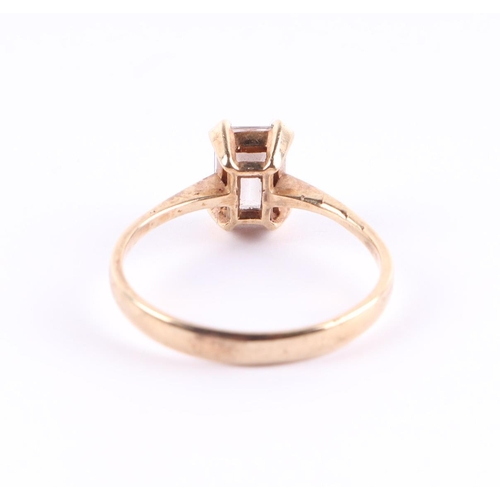 395 - A 9ct gold ring set with a large rectangular white stone, approx UK size P, 2g.