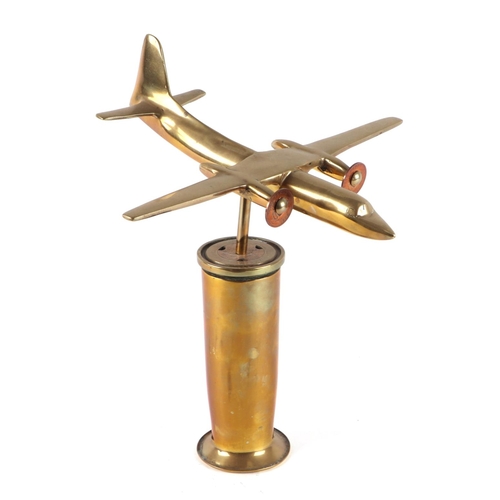 41 - A cast brass model of a twin engine aircraft, mounted on a brass plinth, wingspan 17cm.