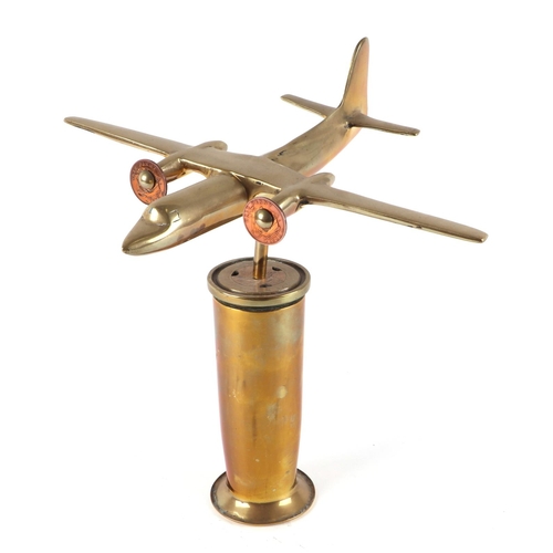 41 - A cast brass model of a twin engine aircraft, mounted on a brass plinth, wingspan 17cm.