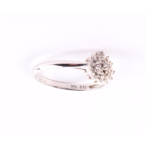 418 - A 9ct white gold diamond cluster ring, approx UK size R, 2.2g.