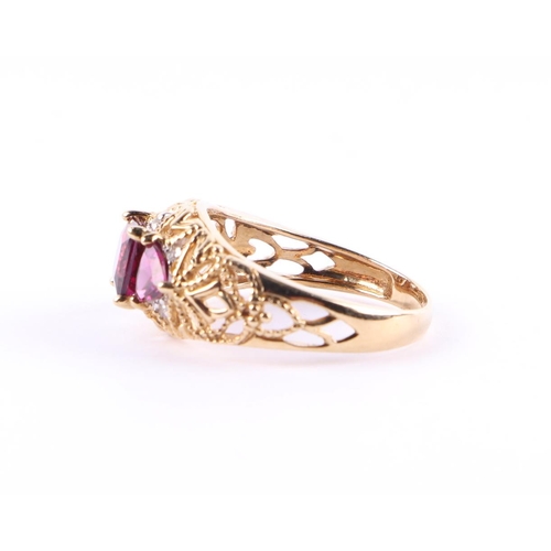 427 - A 9ct gold dress ring set with three purple stones and small diamonds, approx UK size L, 2.6g.