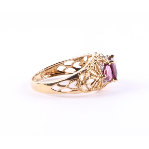 427 - A 9ct gold dress ring set with three purple stones and small diamonds, approx UK size L, 2.6g.