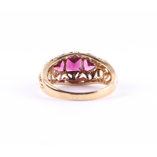 427 - A 9ct gold dress ring set with three purple stones and small diamonds, approx UK size L, 2.6g.