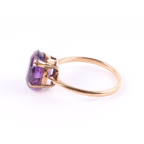 428 - A 9ct gold ring set with a large oval amethyst, approx UK size Q, 2.7g.