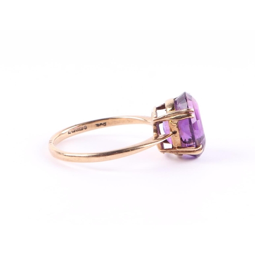 428 - A 9ct gold ring set with a large oval amethyst, approx UK size Q, 2.7g.