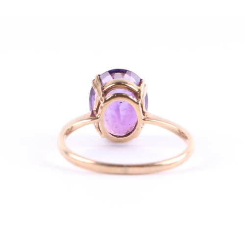 428 - A 9ct gold ring set with a large oval amethyst, approx UK size Q, 2.7g.