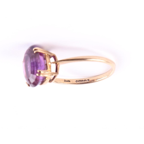 428 - A 9ct gold ring set with a large oval amethyst, approx UK size Q, 2.7g.