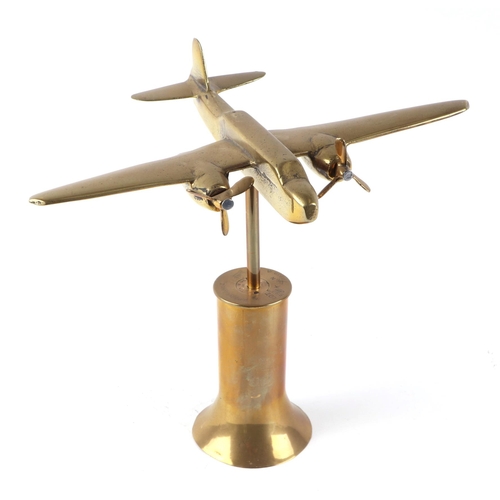 43 - A trench art cast brass model of twin engine aircraft, mounted on a brass plinth, wingspan 26cm.