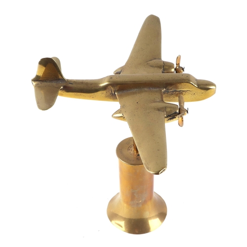 43 - A trench art cast brass model of twin engine aircraft, mounted on a brass plinth, wingspan 26cm.