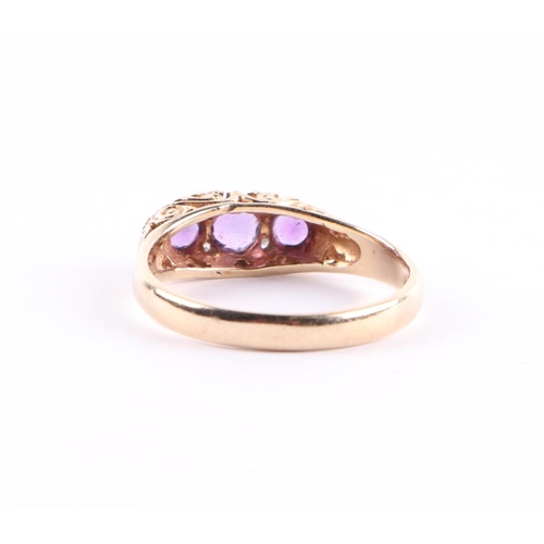 436 - A 9ct gold ring set with three amethysts interspersed with small diamonds, approx UK size P, 2.8g.