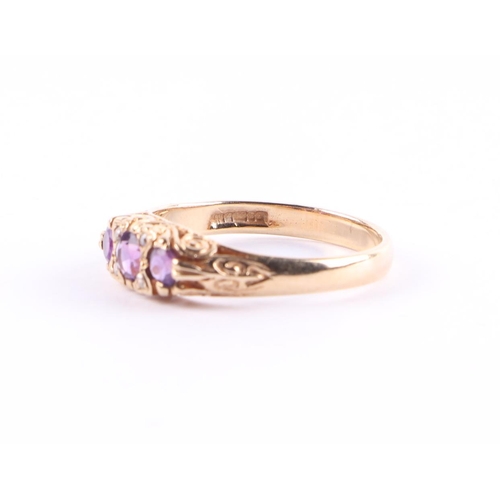 436 - A 9ct gold ring set with three amethysts interspersed with small diamonds, approx UK size P, 2.8g.