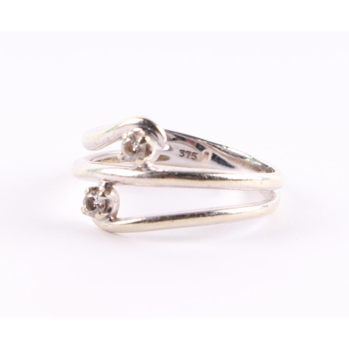 437 - A 9ct white gold modern design two-stone diamond ring, approx UK size N, 2.8g.