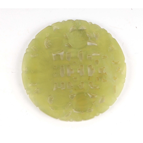 444 - A Chinese jade / hardstone pierced disc, 8cms diameter.