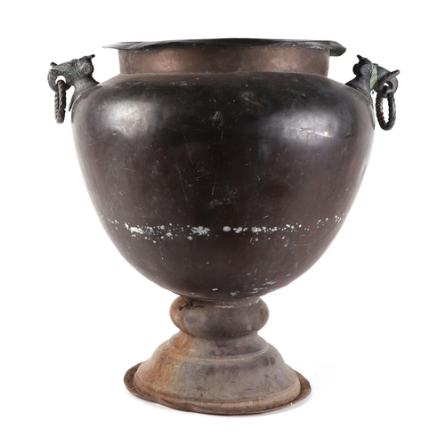 445 - An Indian copper jardinière with mythical beast mask handles, 42cm diameter.