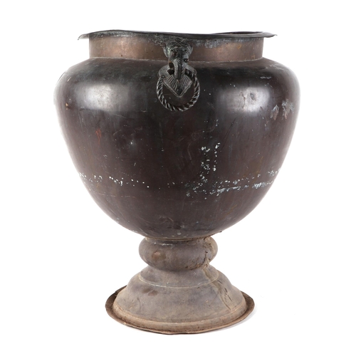 445 - An Indian copper jardinière with mythical beast mask handles, 42cm diameter.