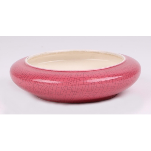 451 - A Chinese pink glazed crackle ware brush washer, with a hardwood stand, 16cm diameter.