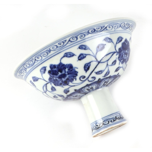 455 - A Chinese blue & white stem bowl decorated with scrolling flowering foliage, 17.5cms diameter.