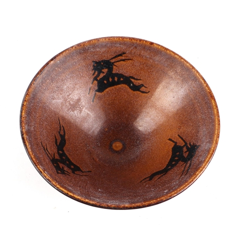 456 - A Chinese pottery bowl decorated with stylised animals, 16cms