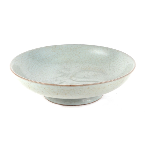 466 - A Chinese crackleware celadon glaze shallow footed bowl with incised decoration in the form of a dee... 