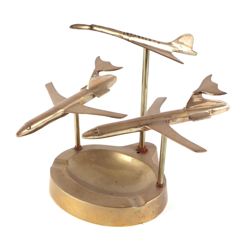 47 - Two DC10 cast brass models and a brass model of Concorde, mounted on a brass ashtray, 25cm wide.