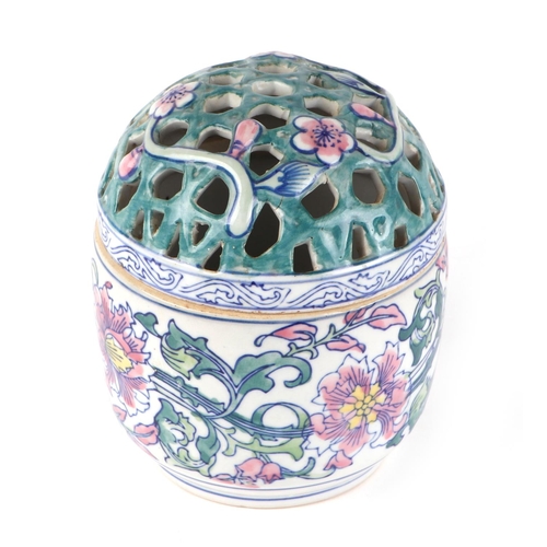 471 - A Chinese famille rose bowl and pierced cover decorated with scrolling flowers, 15cms high.