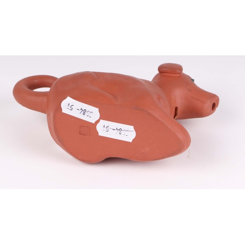 487 - A Chinese Yixing pottery teapot in the form of a recumbent dog, 14cms long.