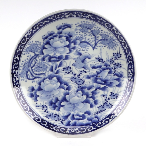 491 - A pair of Japanese blue & white chargers decorated with prunus and birds, each 37cms diameter (2).