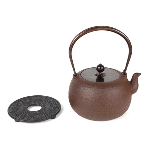 505 - A cast iron Japanese teapot with four character mark to the underside, in its wooden transportation ... 