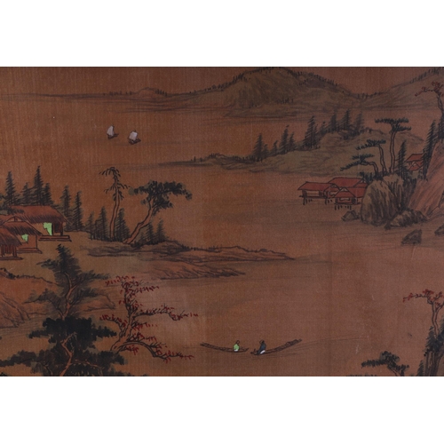 523 - A Chinese painting on silk depicting a mountainous landscape with fishing boats in the foreground, w... 