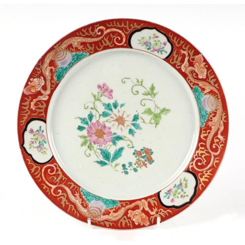 527 - A Chinese famille rose plate decorated with flowers within a dragon border, 25cms diameter; together... 