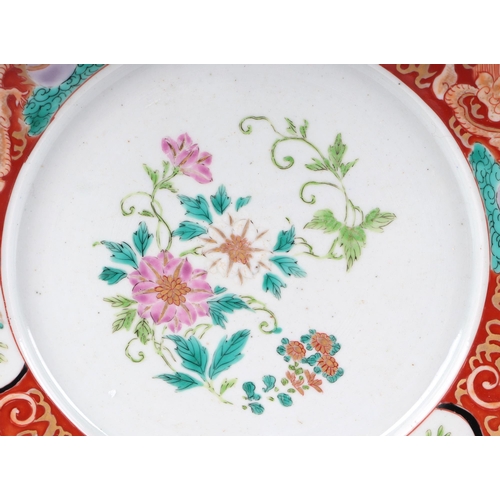 527 - A Chinese famille rose plate decorated with flowers within a dragon border, 25cms diameter; together... 