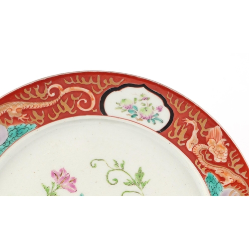 527 - A Chinese famille rose plate decorated with flowers within a dragon border, 25cms diameter; together... 