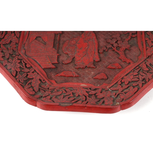 532 - A Chinese cinnabar lacquer octagonal dish decorated with a figure and tiger in a landscape, 30cms wi... 