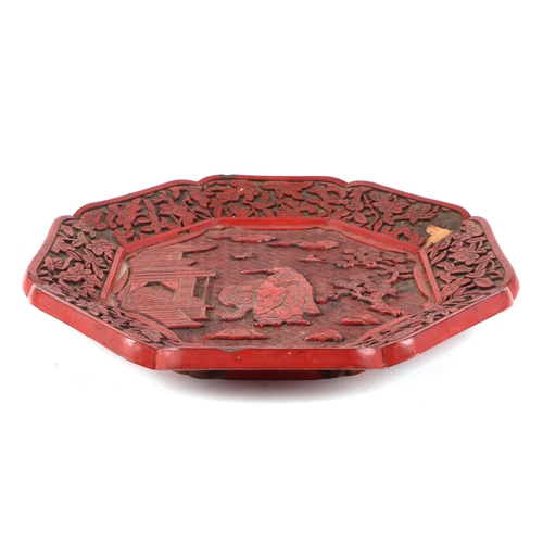 532 - A Chinese cinnabar lacquer octagonal dish decorated with a figure and tiger in a landscape, 30cms wi... 