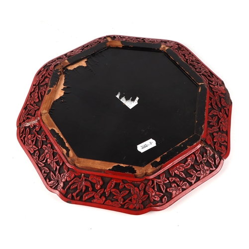 532 - A Chinese cinnabar lacquer octagonal dish decorated with a figure and tiger in a landscape, 30cms wi... 