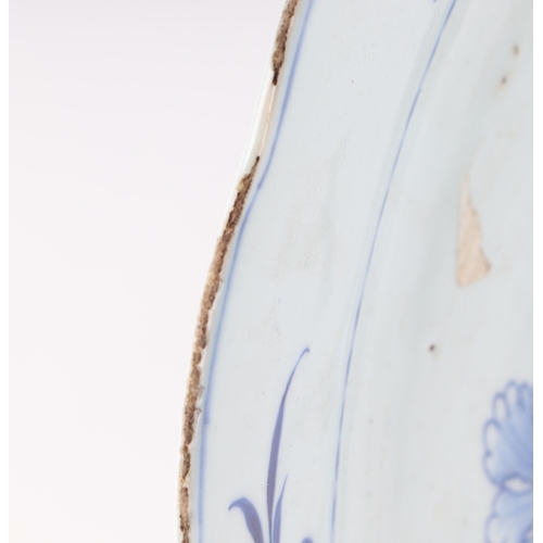 552 - A Chinese blue & white charger decorated with bamboo and flowers, 42cms diameter.