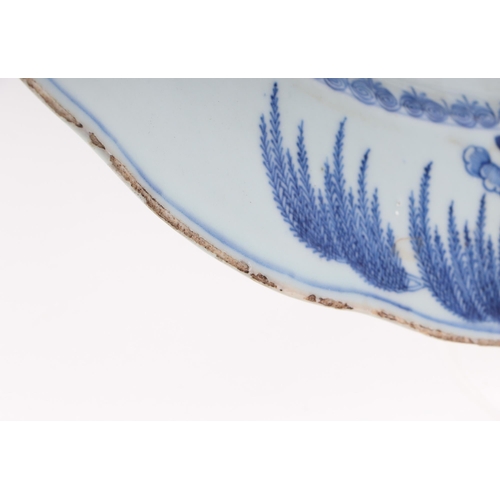 552 - A Chinese blue & white charger decorated with bamboo and flowers, 42cms diameter.