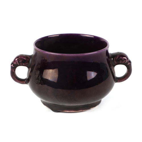 555 - A Chinese aubergine glaze two-handled censer on a hardwood stand, 6cms high, a mottled glazed brush ... 