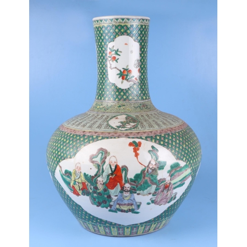 570 - A very large Chinese famille vert vase decorated with flowers within panels (drilled), 50cm high.Con... 