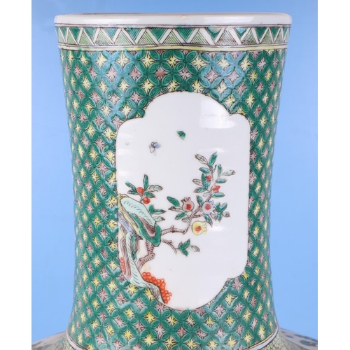 570 - A very large Chinese famille vert vase decorated with flowers within panels (drilled), 50cm high.Con... 