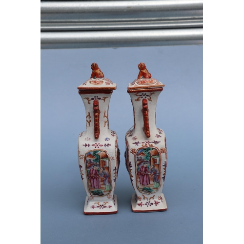 575 - A pair of Chinese Mandarin palette famille rose Export vases and covers moulded in relief with oppos... 