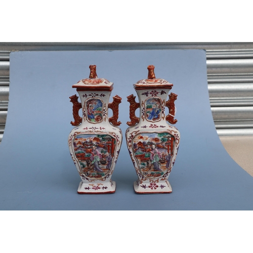 575 - A pair of Chinese Mandarin palette famille rose Export vases and covers moulded in relief with oppos... 