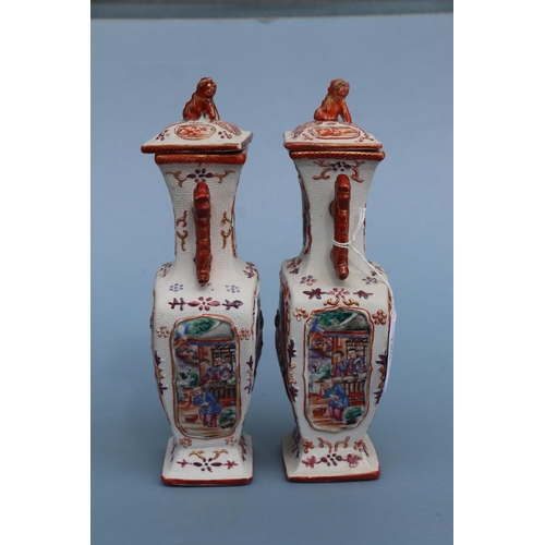 575 - A pair of Chinese Mandarin palette famille rose Export vases and covers moulded in relief with oppos... 