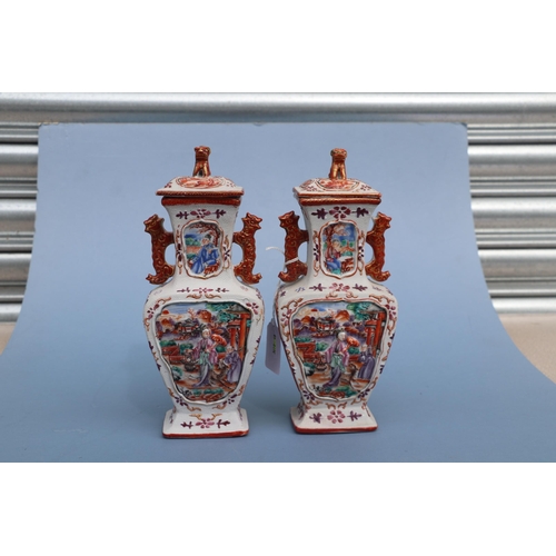 575 - A pair of Chinese Mandarin palette famille rose Export vases and covers moulded in relief with oppos... 