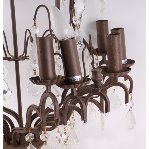 589 - A wrought iron twelve-branch ceiling light with prismatic drops, 73cms high.